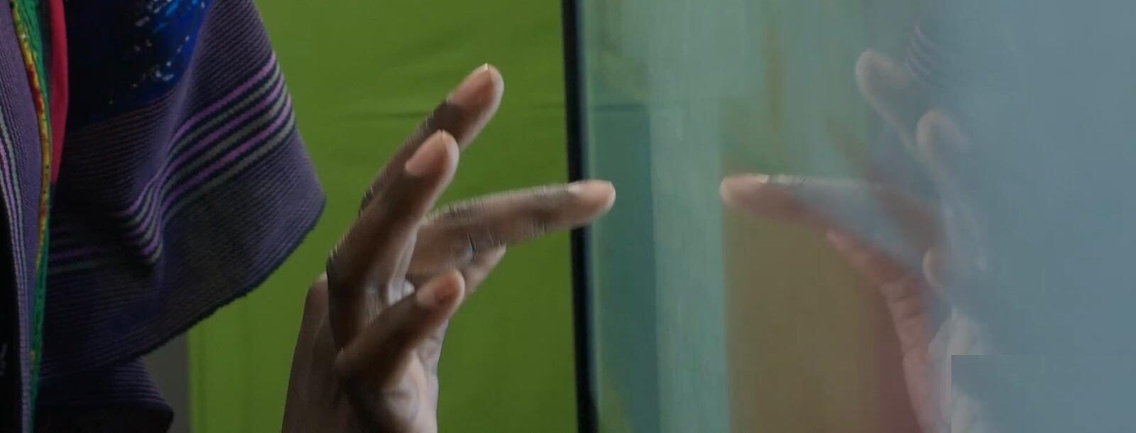 Hand interacting with NDX interactive classroom display